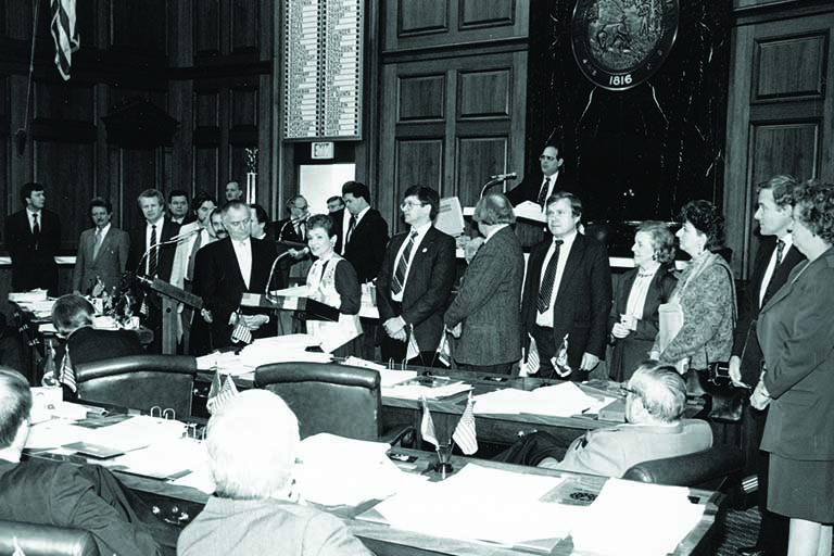 black and white photo of delegates around a table